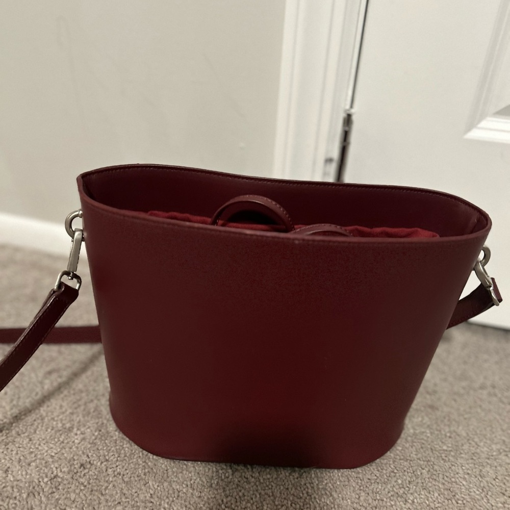 Brand new “Iris & Ink burgundy crossbody purse with adjustable strap.